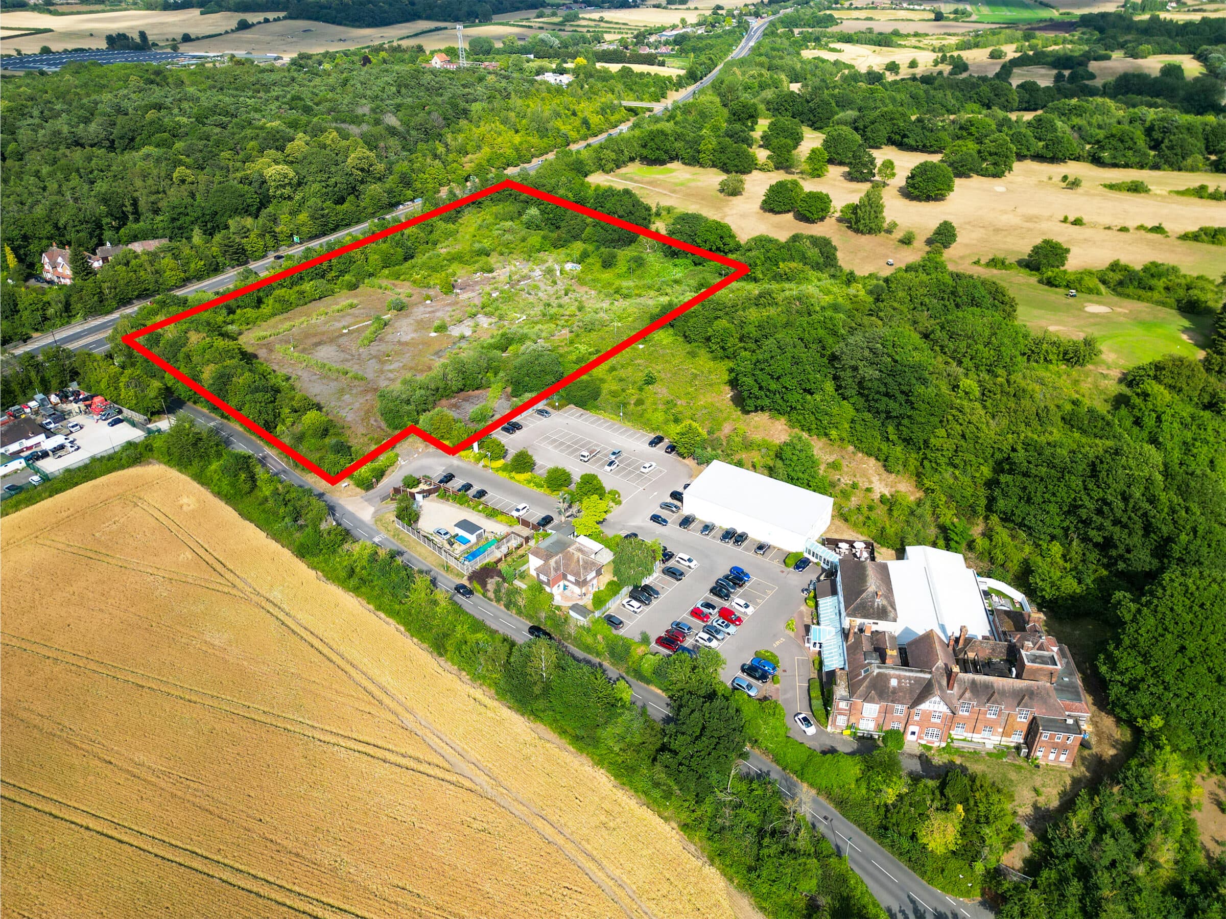 Aerial drone photograph of a country property and its grounds, marked out for marketing.